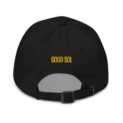 The back of a black cap with the words Good Sol threaded in yellow