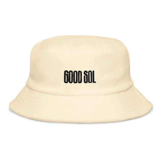 A yellow terry cloth bucket hat with the word Good Sol is threaded at the top.